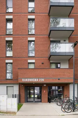 a brick building with bikes parked outside of it at Orange, modern apartment in the city centre in Kraków