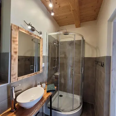 a bathroom with a sink and a shower at Na Szlaku - domki do wynajęcia in Rabka