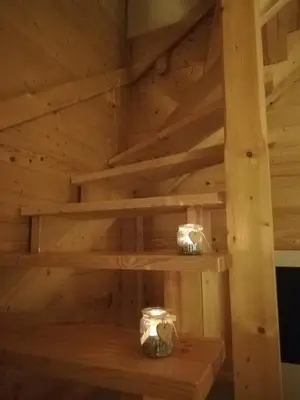 a sauna with wooden shelves and two jars at Na Szlaku - domki do wynajęcia in Rabka