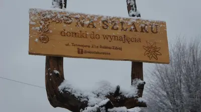 a sign with snow on top of it at Na Szlaku - domki do wynajęcia in Rabka
