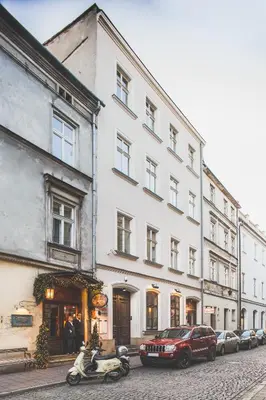 a building with a motorcycle parked in front of it at City Vibes Apartments in Kraków