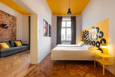 a bedroom with a bed and a couch at City Vibes Apartments in Kraków