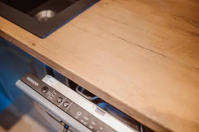 a close up of a wooden counter top with an oven at Exclusive 