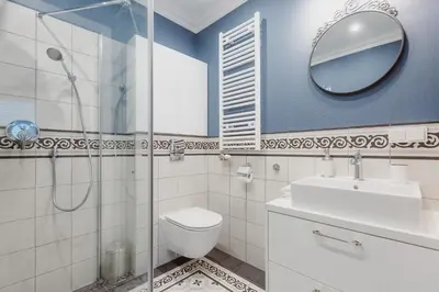 a bathroom with a toilet and a sink and a mirror at Exclusive 