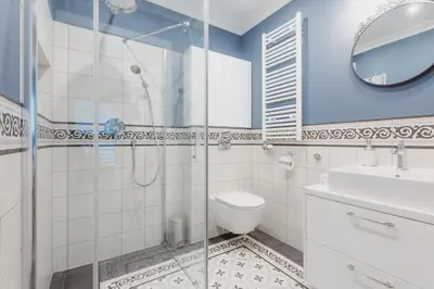 a bathroom with a shower and a toilet and a sink at Exclusive 