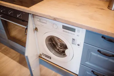 a washer and dryer under a counter in a kitchen at Exclusive 