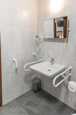 a bathroom with a sink and a mirror at AirPark Balice in Balice
