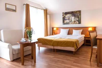 a hotel room with a bed and a chair at AirPark Balice in Balice