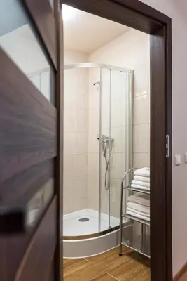a bathroom with a shower with a glass door at AirPark Balice in Balice