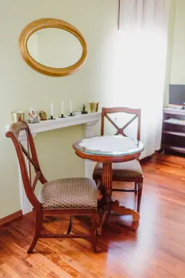 a table and two chairs and a mirror in a room at 100% cracovian traditional apartment in Kraków