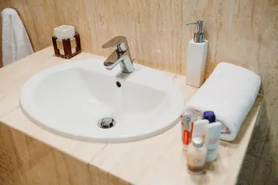 a white sink in a bathroom with toothbrushes at 100% cracovian traditional apartment in Kraków