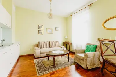 a living room with a couch and a table at 100% cracovian traditional apartment in Kraków
