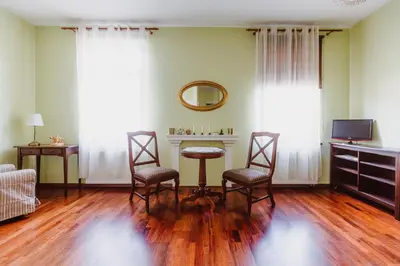 a living room with a table and two chairs at 100% cracovian traditional apartment in Kraków