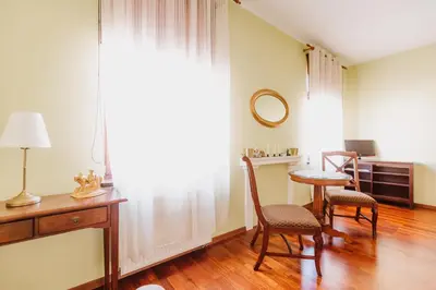 a living room with a table and chairs and a window at 100% cracovian traditional apartment in Kraków