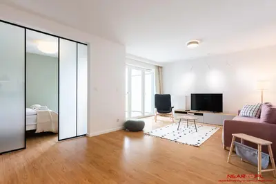 a living room with a couch and a tv at Apartments Nearto Old Town Vermelo in Kraków