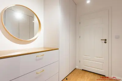 a dressing room with a mirror and a white door at Apartments Nearto Old Town Vermelo in Kraków