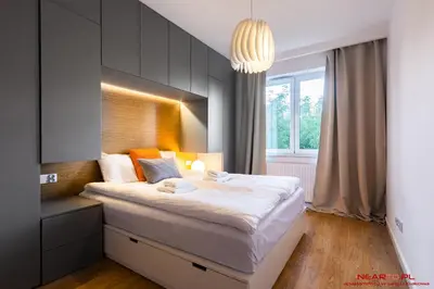 a bedroom with a large bed and a window at Apartments Nearto Old Town Vermelo in Kraków