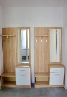 a dressing room with two mirrors and wooden cabinets at Apartamenty ZORZA in Kraków