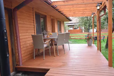 a wooden deck with a table and chairs on it at Domek Anielski in Zator
