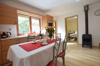 a kitchen with a table with a red napkin on it at Domek Anielski in Zator