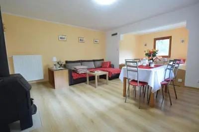 a living room with a table and a couch at Domek Anielski in Zator