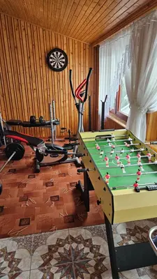 a pool table in a living room with at Agroturystyka U Misia in Niedźwiedź