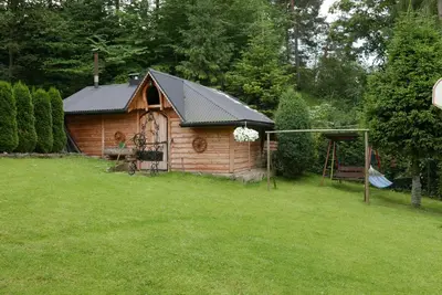 a log cabin in a yard with a gazebo at Agroturystyka U Misia in Niedźwiedź
