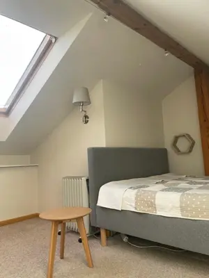 a small bedroom with a bed and a table at OLSZA RESIDENCE Cozy & quiet 2 level apartment in Kraków