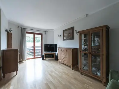a large living room with a television and a wooden floor at OLSZA RESIDENCE Cozy & quiet 2 level apartment in Kraków