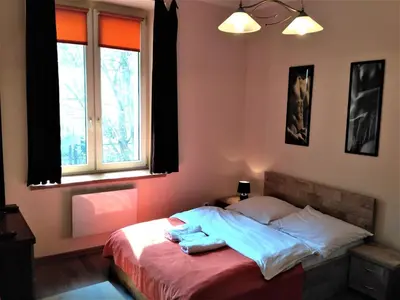 a bedroom with a bed with two towels on it at Akt Studio Apartment City Centre in Kraków