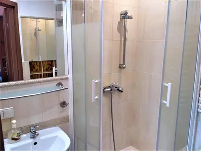 a bathroom with a shower and a sink at Akt Studio Apartment City Centre in Kraków