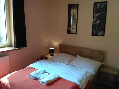 a bed with two towels sitting on top of it at Akt Studio Apartment City Centre in Kraków