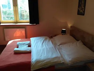 a bed with white sheets and two pillows on it at Akt Studio Apartment City Centre in Kraków