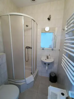 a bathroom with a shower and a toilet and a sink at Hotel TERESITA in Kraków