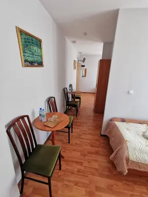 a bedroom with a bed and a table and chairs at Hotel TERESITA in Kraków