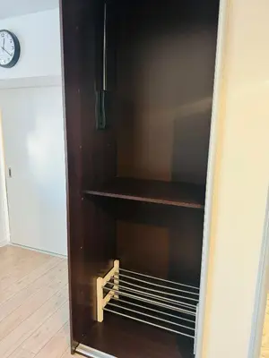 a brown refrigerator with empty shelves and a clock at Villa Vincentów in Myślenice
