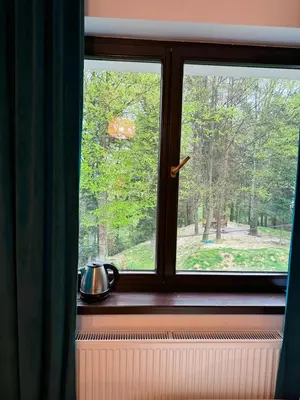 a window with a tea pot sitting on a window sill at Villa Vincentów in Myślenice