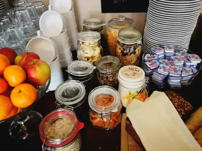 a table with jars of food and fruit on it at QUEST HOTEL - dawniej Hotel Planeta in Brzesko