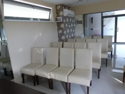 a row of white chairs in a room at QUEST HOTEL - dawniej Hotel Planeta in Brzesko