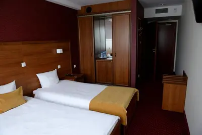a hotel room with two beds and a window at QUEST HOTEL - dawniej Hotel Planeta in Brzesko