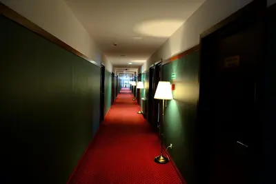a long hallway with a red carpet and a lamp at QUEST HOTEL - dawniej Hotel Planeta in Brzesko