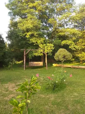 a garden with a gazebo in the middle of a field at Zajazd Joniec Małgorzata in Dobra