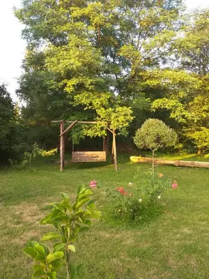 a garden with a gazebo in the grass at Zajazd Joniec Małgorzata in Dobra