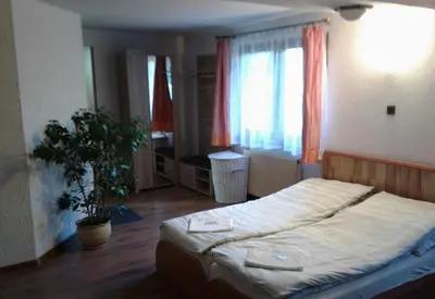 a bedroom with a bed and a potted plant at Zajazd Joniec Małgorzata in Dobra