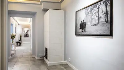 a hallway with a picture of two people on a wall at Flaminio Smart Sleep in Kraków
