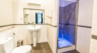 a bathroom with a toilet sink and a shower at Flaminio Smart Sleep in Kraków