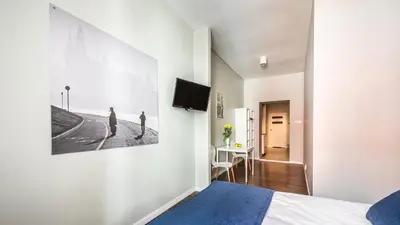 a bedroom with a bed and a picture on the wall at Flaminio Smart Sleep in Kraków
