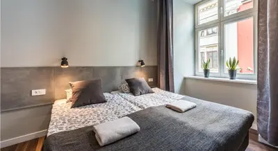 a bedroom with a large bed with two pillows at Flaminio Smart Sleep in Kraków