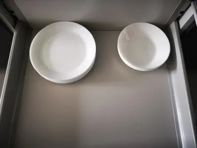 two white plates are hanging on a wall at Apartament Cyprys 2 in Oświęcim