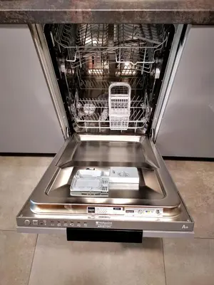 an open dishwasher with dishes inside of it at Apartment Cyprys 1 in Oświęcim